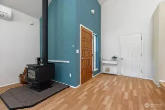 Welcome to your warm and inviting new home! Wood Stove and Mini-split on the left and door against the white wall opens to the one car garage.