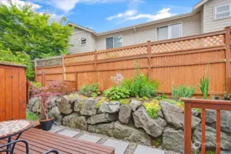 Gorgeous landscaping in the back yard.  Enjoy summer nights on BBQ's on your private deck.