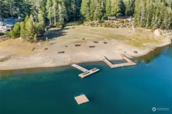 Zoomed in view of community park. Docks, volleyball court, horshoe, playground and picnic/BBQ area.