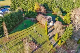 Aerial view of the front driveway, yard and back fenced yard.