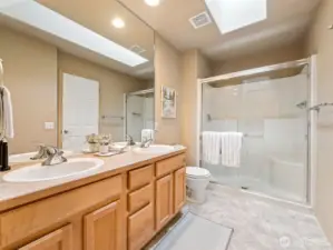 - With double sinks & large walk-in shower + skylight for natural lighting!
