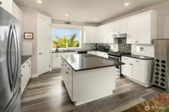 This modern kitchen will satisfy any cook. Solid surface counters and a spacious center island for meal prep and holiday buffets.