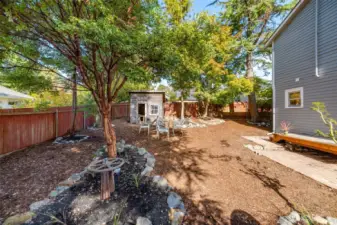 Large back yard with established trees and landscaping