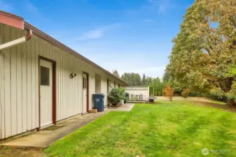 The first man door is the exit from the one car garage into the back yard of the complex.