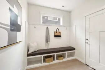 Large mudroom with bench seat, cubbies & more storage