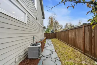 Grassy side yard with raised bed and garden space