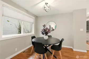 The dining area is adjacent to the kitchen for ease of cooking and serving.