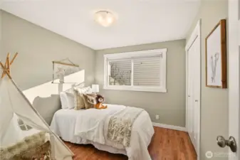 The third main floor bedroom is located across the hall from the remodeled full bath and is staged as a nursery.