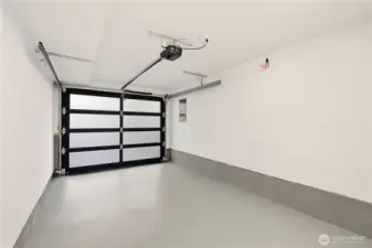 Yes, a beautifully finished and painted one car garage with utility closet that houses the furnace and hot water heater and provides additional storage. Just outside the garage on the south side of the home is a Emporia car charger that conveys to buyers.