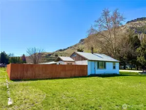 New fence completely encloses back yard.