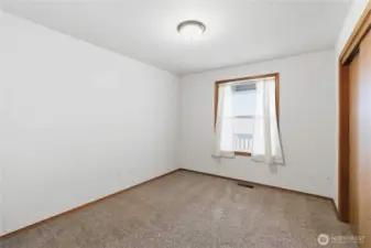 First bedroom on the left going down the hallway, perfect for an office or craft room.
