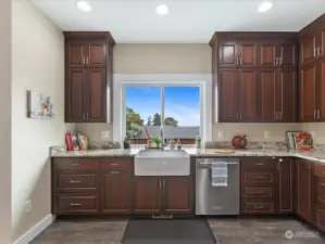 Beautiful open Kitchen, deep sink with view out to fenced Backyard & partial view.