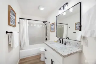 Enjoy Quartz counters, & new vanity, lighting, fixtures, and hardware in the guest bathroom.