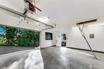 Perched just above the main residence, the 520 SF Coach House offers secure garage parking for two vehicles, with additional space for tools or a small workshop. Recent upgrades include a new roof, LED lighting, epoxy-sealed concrete floors, and a 200-amp electrical panel—ideal for modern shop needs or future EV charging. A finished attic loft provides added storage, while the private stair connection to the main home offers both convenience and a sense of cohesion across the property.