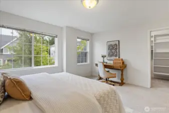 Large-sized Guest Bedroom with a walk-in closet and closet system.