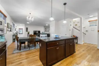 Open concept kitchen with upgraded lighting, hardwood floors