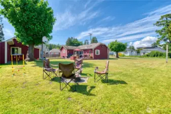 View of primary home, fantastic yard and guest cottage
