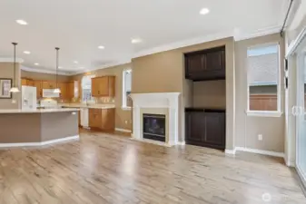 Custom wood built in next to fireplace could serve as a wet bar or dry bar, also a tv stand