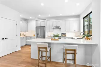 Everything you’d expect from a Janzen Custom Builders home! Gorgeous quartz counters, a spacious pantry, stainless steel appliances, and undercabinet lighting make this kitchen as functional as it is beautiful.