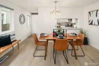 Dining Room opens to breaskfast/serving bar off the Kitchen. This main floor living also opens to the private fenced backyard off the kitchen door.
