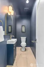 Powder room just off living room, near garage entrance.