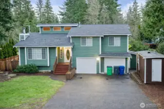 Beautiful home with two separate garages, plenty of drivway parking and several storage options.