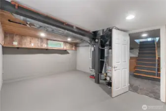 The basement entry is home to the  furnace and water heater.  Tons of room for storage or an extra fridge & freezer.
