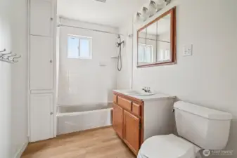 Full bath with tile tub surround and new flooring