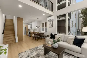 The dining room opens into a a spacious and bright living room with a large loft overlooking  the space below.