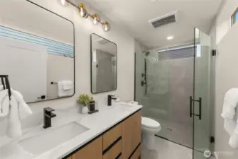 Luxury finishes fill the en-suite primary bath.