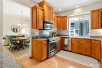 Kitchen features gorgeous cabinetry and newer appliances plus plenty of space to move around.