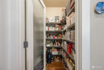 Keep your kitchen organized with this spacious walk-in pantry, offering plenty of shelving for all your storage needs.