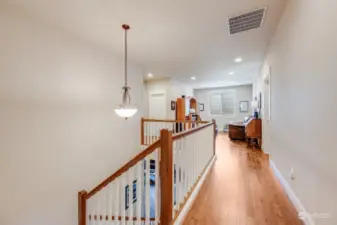 The spacious upstairs hallway provides easy access to all the bedrooms and additional living areas.
