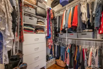 The expansive walk-in closet offers plenty of storage space with custom shelving and drawers.