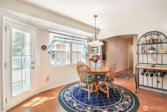 Spacious eating nook off the kitchen with   door out to the entertainment sized deck which is so private.      going out  to the entertainment sized deck
