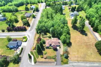 This 2.3 acre corner homesite offers space and privacy in desirable neighborhood