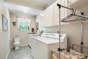 Now this is the 1/2 bath off the garage with laundry room full of cabinets counter space and sink!