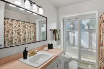 Vintage vibes in this hallway bathroom with access to the outside patio and pool via slider.