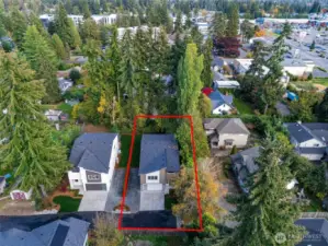 This oversized lot extends beyond the tree line to the rear white fence, offering a rare blend of privacy and highly usable outdoor space — ideal for entertaining, custom landscaping, or future additions — all complemented by RV parking for boats, campers, and every lifestyle upgrade.