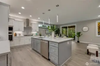 The heart of this home, a modern chef’s kitchen dazzles with pristine quartz countertops, top-of-the-line stainless steel appliances, and an abundance of custom cabinetry — blending exquisite design with effortless functionality.