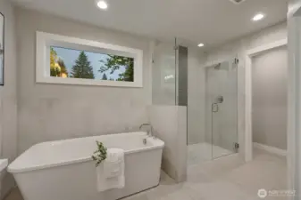 Immerse yourself in tranquility with a luxurious soaking tub, paired with a large, glass-enclosed shower — a harmonious blend of comfort and sophistication.