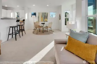 View of window nook, dining area and kitchen.