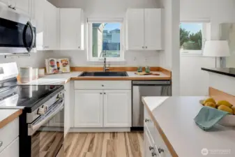 Kitchen featuring new floors.