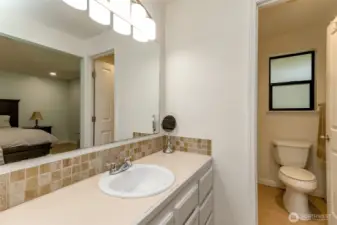 Primary bathroom vanity. Water closet with full shower.