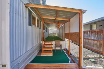 Covered porch with golf putting green.