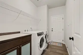 Laundry on main by stairs leading to flex space upstairs.