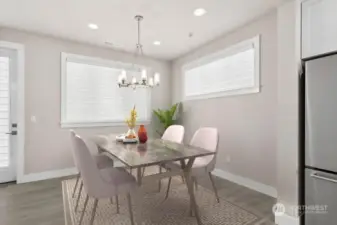 Roomy dining area with modern fixtures opens to large covered Trex deck!