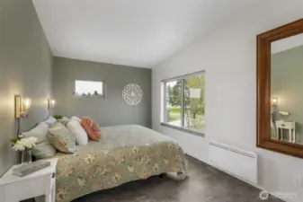 The primary bedroom offers soft, calming tones and beautiful light from two directions.