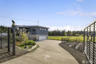 Private gated entrance welcomes you to a wide driveway and beautifully landscaped grounds.