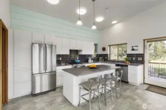 Light-filled living and dining area with expansive windows framing peaceful natural views.
